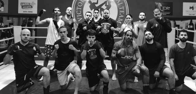 Black and white portrait of a dance instructor against a light background.