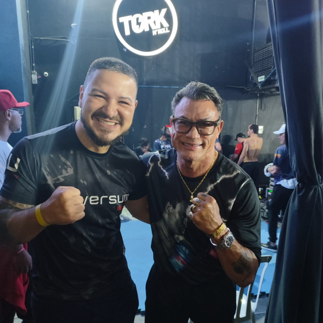 Black and white photo of a women performing modern dance on a dark background.